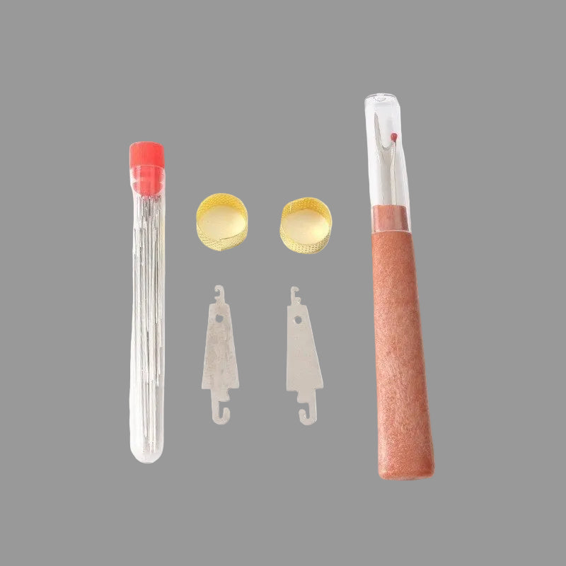 Set of sewing needles, thread, and a pink-handled needle case on a white background